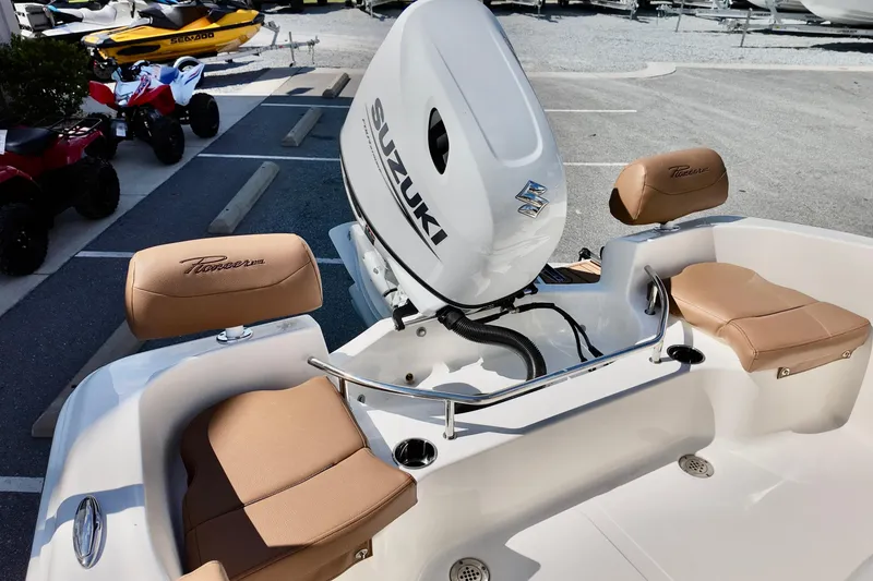 Slide: The Image of 2026 Pioneer 202 Sportfish boat with Suzuki outboard motor and tan seating. - 9