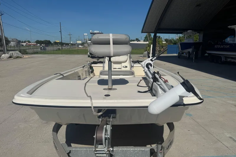 Slide: The Image of 2021 Mako Pro Skiff 19 CC boat on trailer, parked outdoors under clear sky. - 10