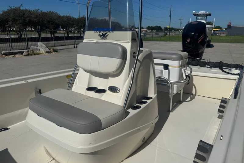 Slide: The Image of 2021 Mako Pro Skiff 19 CC boat interior with seating and console. - 11