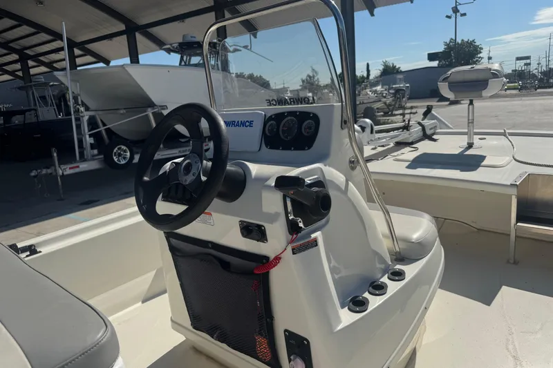 Slide: The Image of 2021 Mako Pro Skiff 19 CC boat interior with steering console and seating. - 14