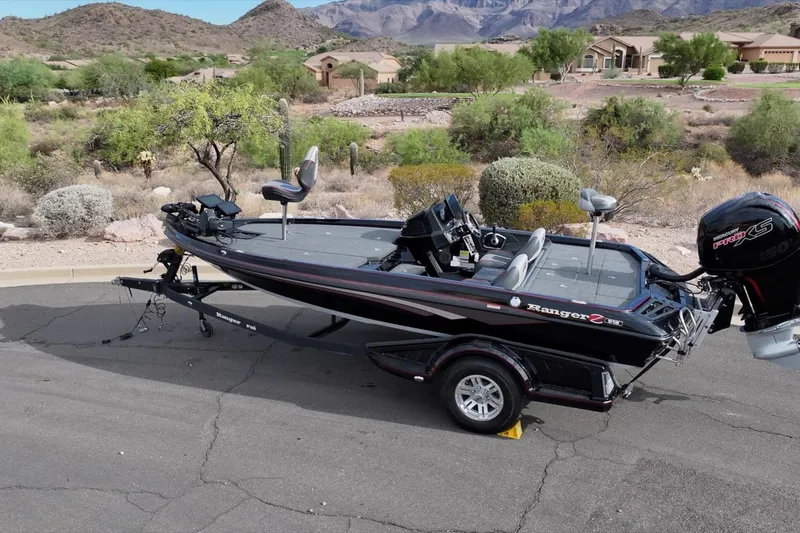 Slide: The Image of 2024 Ranger Z518 boat on trailer, desert landscape background, showcasing sleek design and powerful engine. - 12