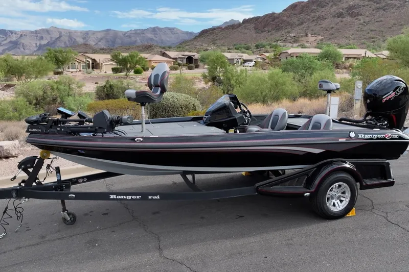 Slide: The Image of 2024 Ranger Z518 boat on trailer, scenic mountain backdrop. - 21