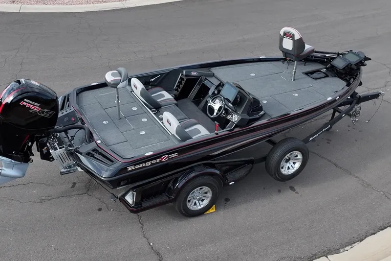 Slide: The Image of 2024 Ranger Z518 boat on trailer, featuring spacious deck and modern design. - 23