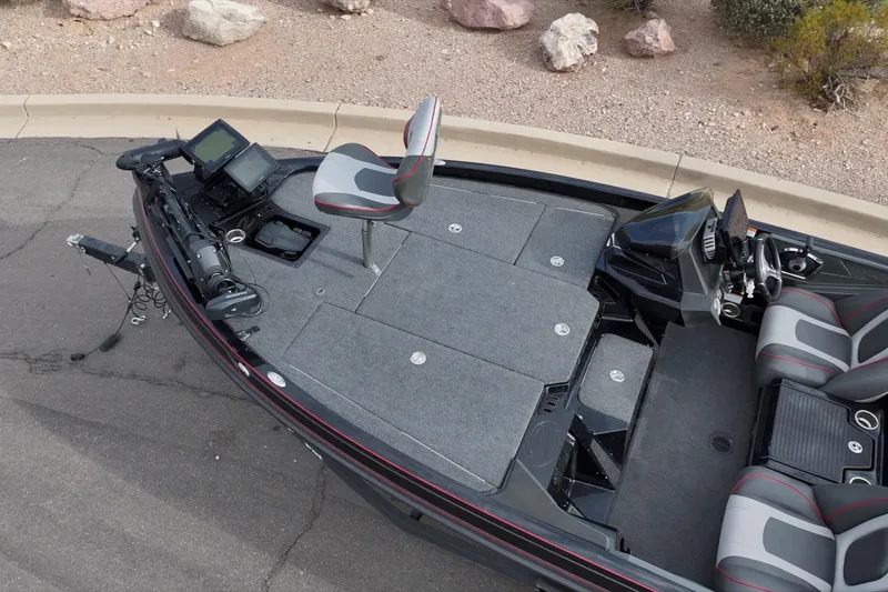 Slide: The Image of 2024 Ranger Z518 fishing boat with advanced electronics and seating, parked on pavement. - 26