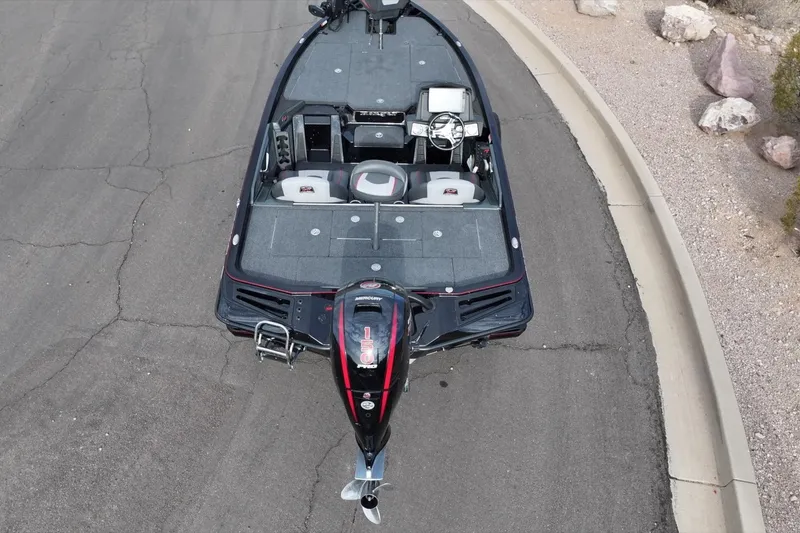 Slide: The Image of 2024 Ranger Z518 boat on pavement, aerial view, showcasing interior layout and motor. - 7