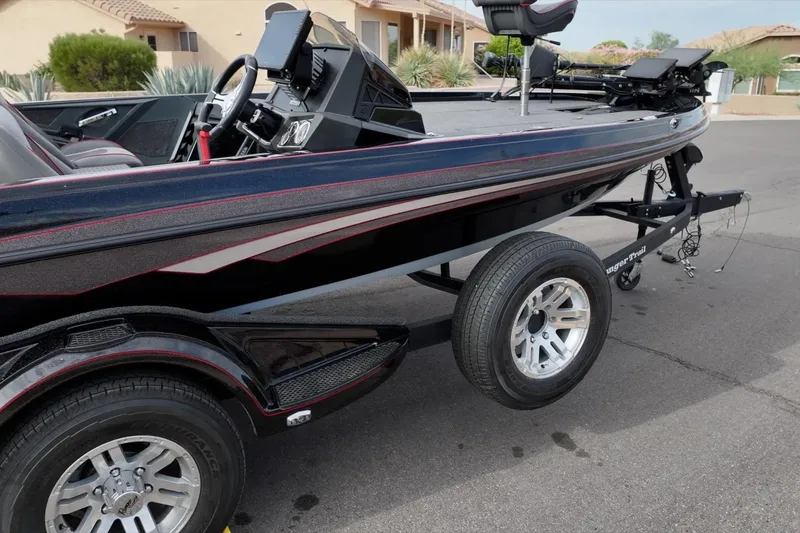 Slide: The Image of 2024 Ranger Z518 boat on trailer, sleek design, black with red accents. - 8