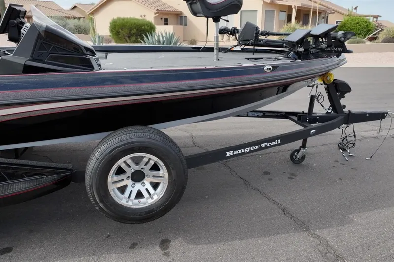 Slide: The Image of 2024 Ranger Z518 boat on trailer, parked on street near residential area. - 9