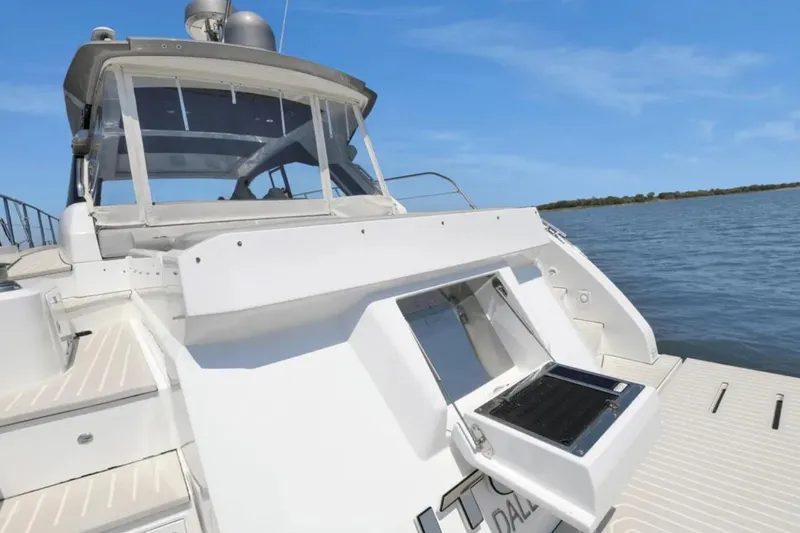 Slide: The Image of Azimut 51 Atlantis 2020 yacht, rear view, with "Utopia" nameplate, docked on calm water. - 12