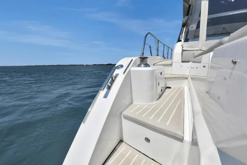 Slide: The Image of Azimut 51 Atlantis 2020 yacht deck overlooking serene blue waters and distant shoreline. - 18