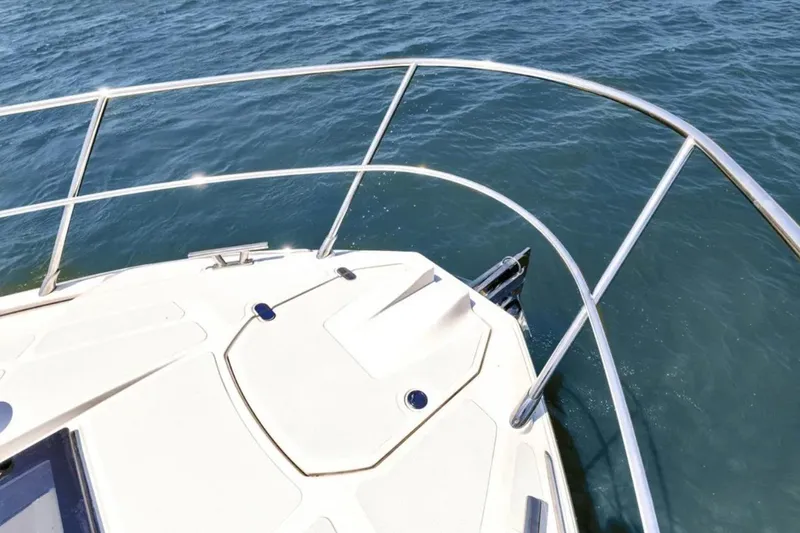 Slide: The Image of Azimut 51 Atlantis 2020 yacht cruising on a serene lake under a clear blue sky. - 24