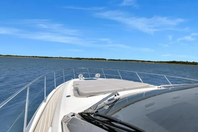 Slide: The Image of 2020 Azimut 51 Atlantis yacht cruising on open water under clear blue skies. - 26