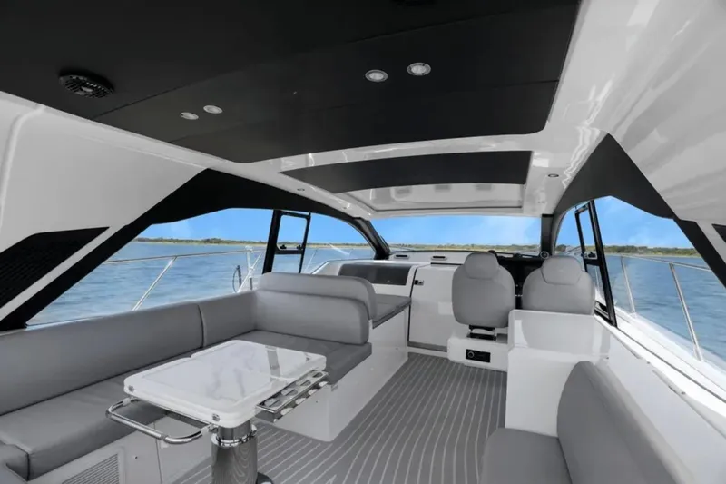 Slide: The Image of 2020 Azimut 51 Atlantis yacht cruising on a serene blue lake under clear skies. - 27