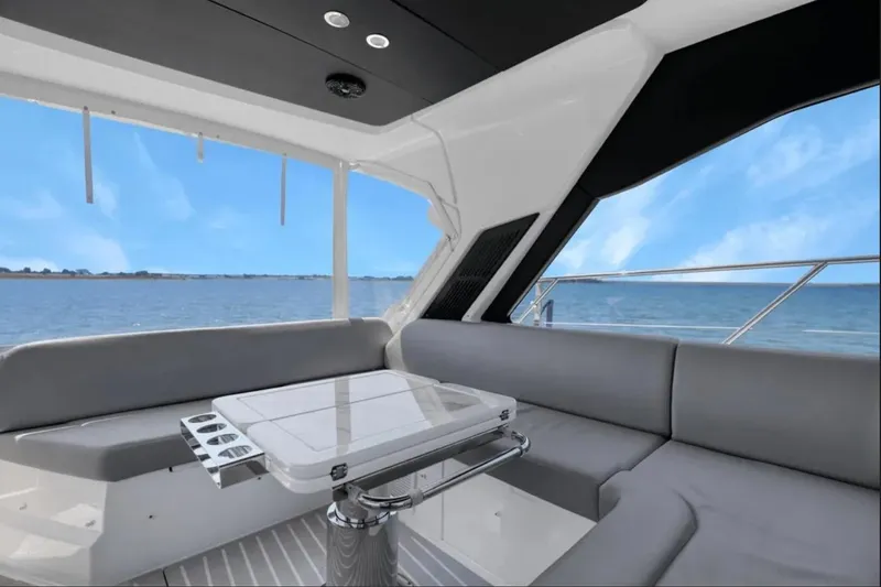 Slide: The Image of 2020 Azimut 51 Atlantis yacht interior with ocean view and sleek seating area. - 37