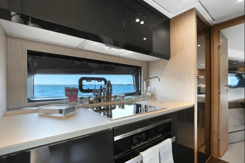 Slide: The Image of Luxurious interior of 2020 Azimut 51 Atlantis yacht with modern kitchen and TV. - 48