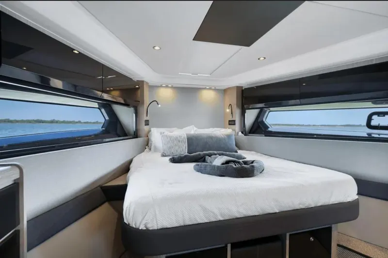 Slide: The Image of Luxurious interior of 2020 Azimut 51 Atlantis yacht with modern seating and elegant staircase. - 53