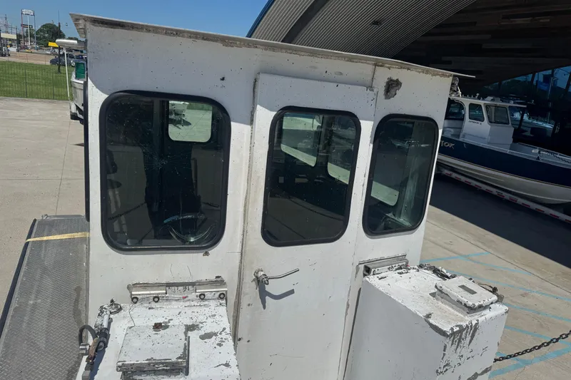 Slide: The Image of Custom Aluminum Work Boat 33, 2010 model, docked with visible cabin and windows. - 11