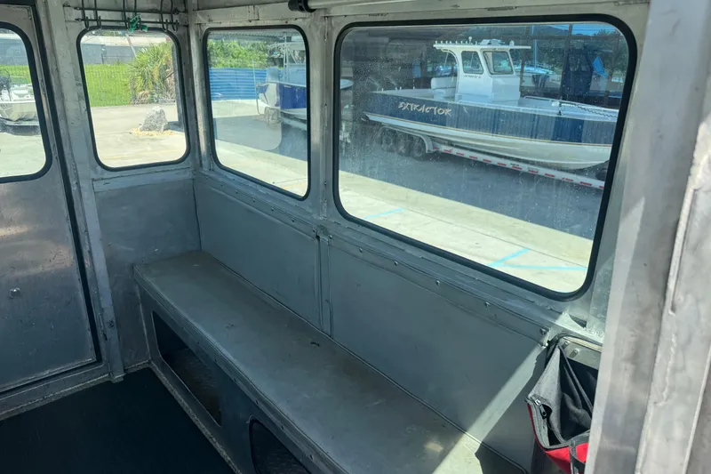 Slide: The Image of Interior of 2010 Custom Aluminum Work Boat 33 with bench seating and windows. - 13
