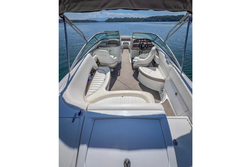 Slide: The Image of Interior of a 2003 Cobalt 240 boat with white seating and open water view. - 17