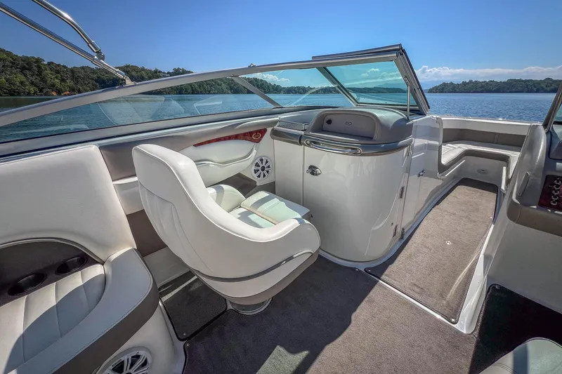 Slide: The Image of Interior of a 2003 Cobalt 240 boat with white seating and open water view. - 19
