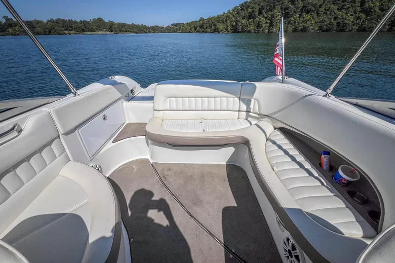 Slide: The Image of Interior of 2003 Cobalt 240 boat with white seating, on a serene lake. - 25