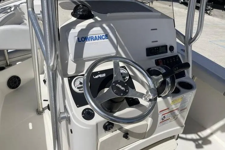 Slide: The Image of 2020 Mako 214 Center Console boat dashboard with steering wheel and Lowrance electronics. - 10