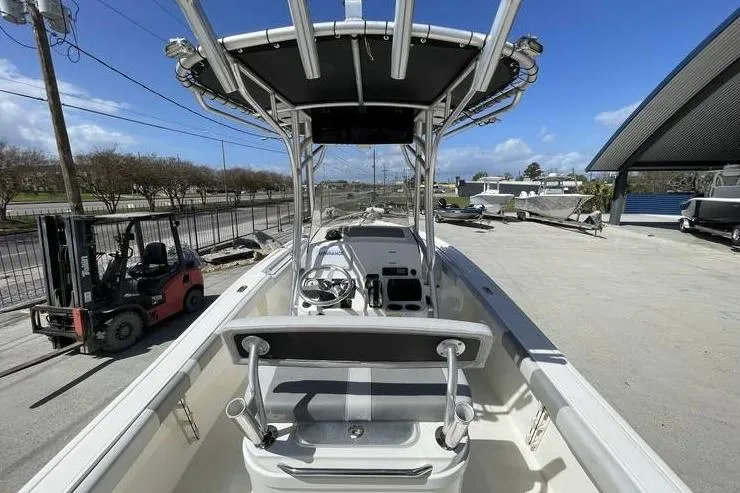 Slide: The Image of 2020 Mako 214 Center Console boat with T-top, parked outdoors on a sunny day. - 13