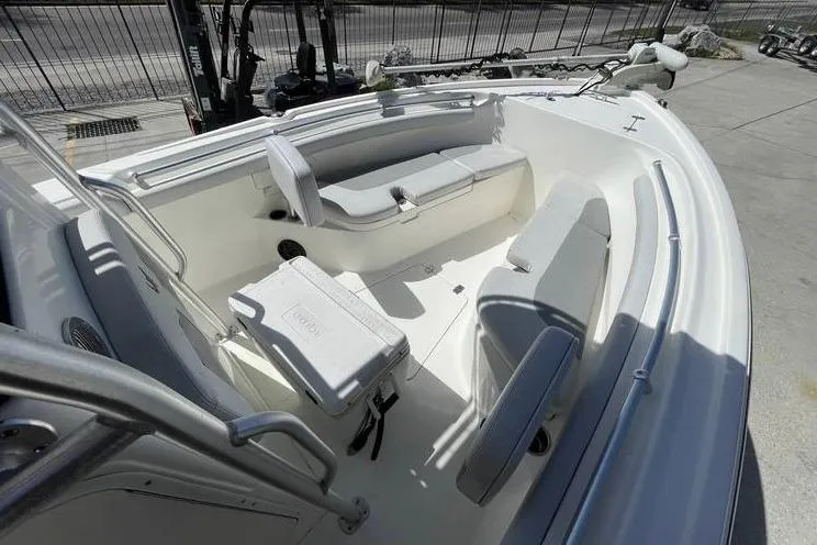 Slide: The Image of 2020 Mako 214 Center Console boat interior with seating and cooler on deck. - 14