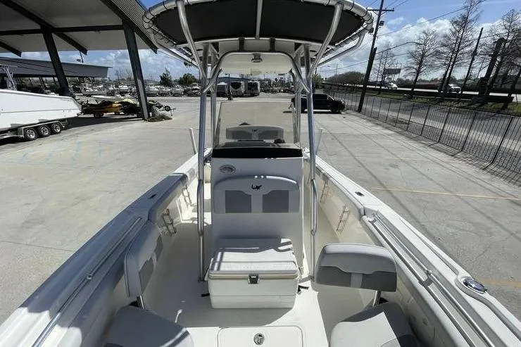 Slide: The Image of 2020 Mako 214 Center Console boat with T-top in a marina setting. - 16