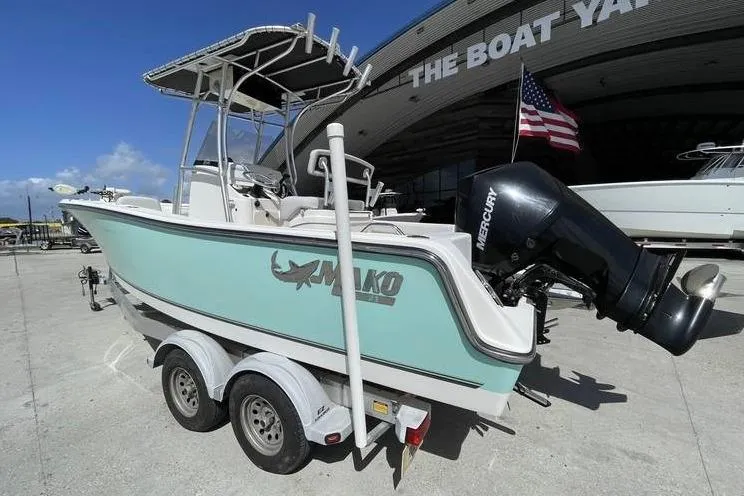 Slide: The Image of 2020 Mako 214 Center Console boat on trailer at marina with American flag. - 3