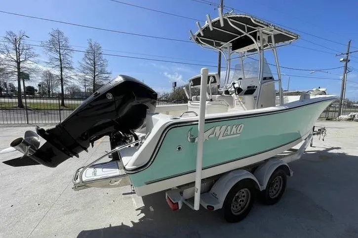 Slide: The Image of 2020 Mako 214 Center Console boat on trailer, featuring a powerful outboard motor. - 4