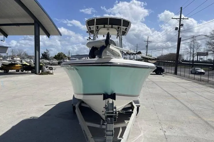Slide: The Image of 2020 Mako 214 Center Console boat on trailer, parked outdoors under a cloudy sky. - 6