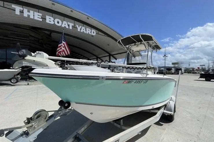 Slide: The Image of 2020 Mako 214 Center Console boat at The Boat Yard, displayed on a trailer. - 7