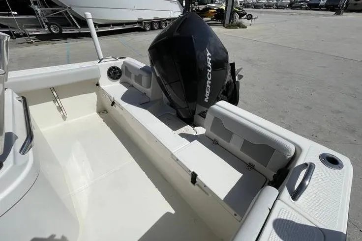 Slide: The Image of 2020 Mako 214 Center Console boat with Mercury engine, docked in a marina. - 9