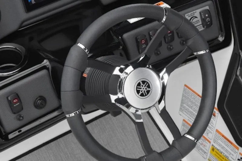 Slide: The Image of Steering wheel of 2025 Yamaha Boats AR195, featuring sleek design and control panel. - 4