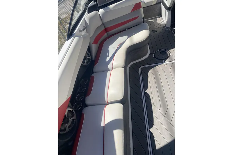 Slide: The Image of 2017 Malibu Wakesetter 23 LSV interior with white and red seating, gray flooring. - 1