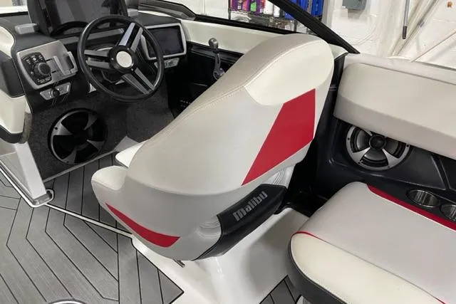 Slide: The Image of 2017 Malibu Wakesetter 23 LSV interior with red and white seating, modern dashboard, and steering wheel. - 6