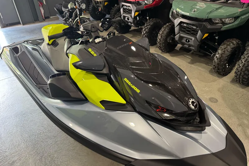 Slide: The Image of 2024 Sea-Doo RXP-X 325 jet ski in showroom, featuring sleek design and vibrant colors. - 11