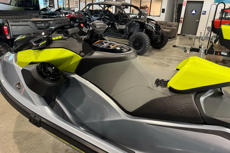 Slide: The Image of 2024 Sea-Doo RXP-X 325 jet ski in showroom, featuring sleek design and vibrant colors. - 5