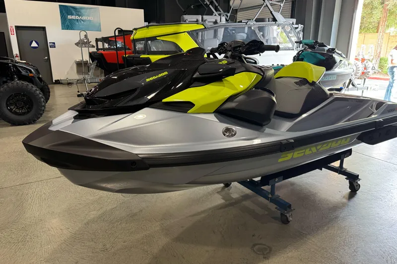 Slide: The Image of 2024 Sea-Doo RXP-X 325 jet ski in showroom, featuring sleek design and vibrant colors. - 6