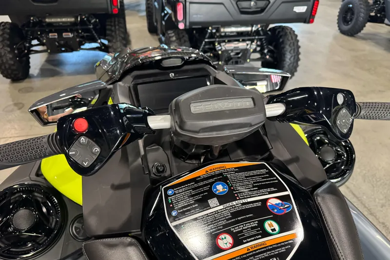 Slide: The Image of 2024 Sea-Doo RXP-X 325 handlebars and dashboard, featuring control buttons and safety instructions. - 7
