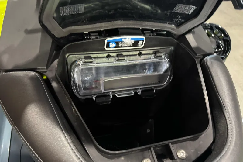 Slide: The Image of 2024 Sea-Doo RXP-X 325 storage compartment with open lid, showcasing interior details. - 8