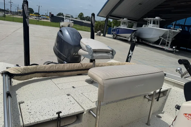 Slide: The Image of 2015 Xpress H20 boat with Yamaha engine, parked outdoors near other boats. - 12