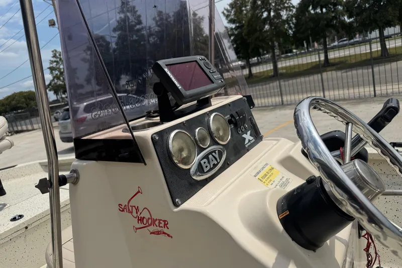 Slide: The Image of 2015 Xpress H20 boat dashboard with steering wheel and navigation equipment. - 13