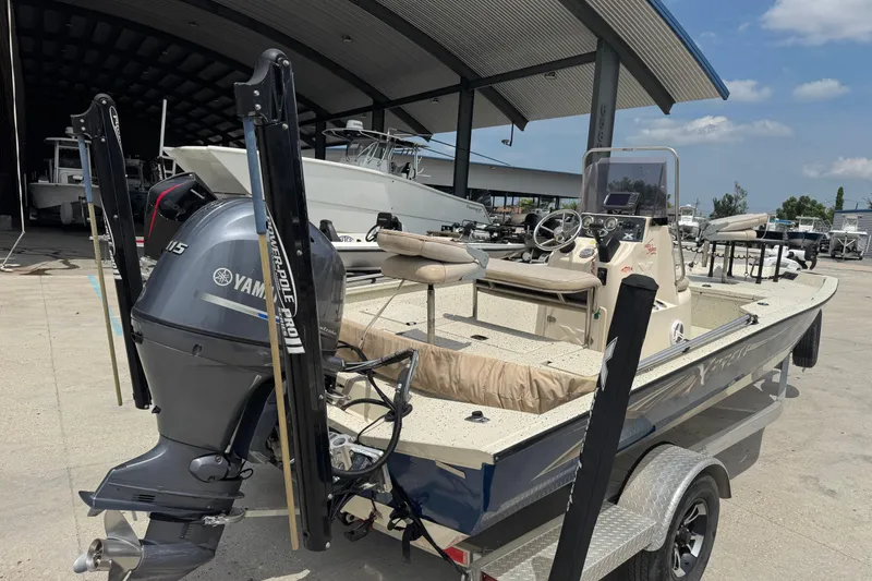 Slide: The Image of 2015 Xpress H20 boat with Yamaha motor, parked in a marina under a canopy. - 3