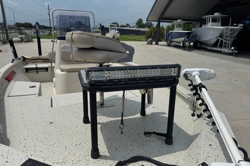 Slide: The Image of 2015 Xpress H20 boat interior with seating and equipment, parked near other boats. - 8