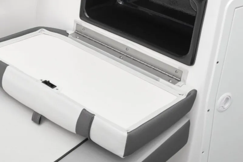 Slide: The Image of 2025 Yamaha Boats AR220 storage compartment with cushioned seating and sleek design. - 2