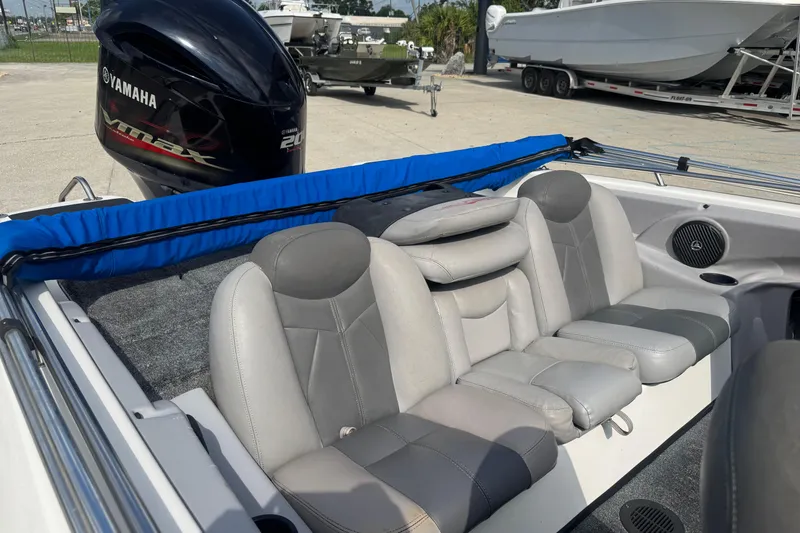 Slide: The Image of 2012 Skeeter SL210 boat interior with Yamaha engine, featuring gray seating and blue accents. - 14