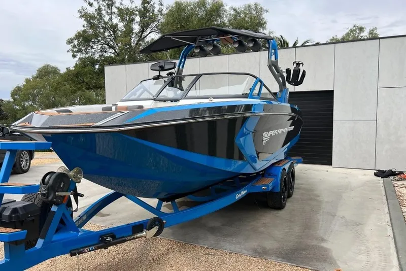 Slide: The Image of 2018 Nautique Super Air Nautique G23 boat on trailer, parked outdoors. - 1