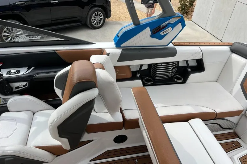 Slide: The Image of 2018 Nautique Super Air Nautique G23 interior with white and brown seating, modern design. - 5