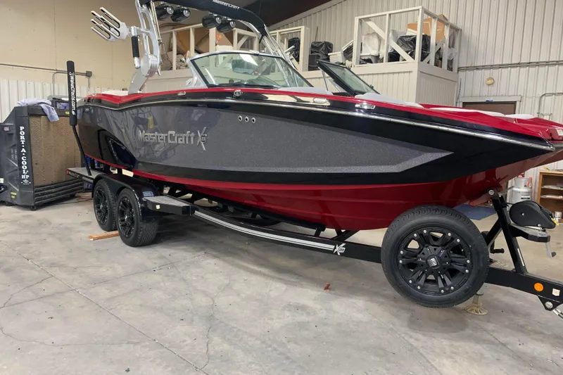 Slide: The Image of 2017 MasterCraft X23 boat on trailer in indoor storage facility. - 1